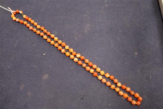 An early 20th century banded agate and other hardstone bead necklace, 80cm.